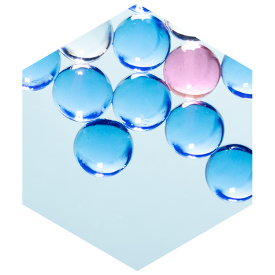 Clear blue and pink water beads on a light blue background