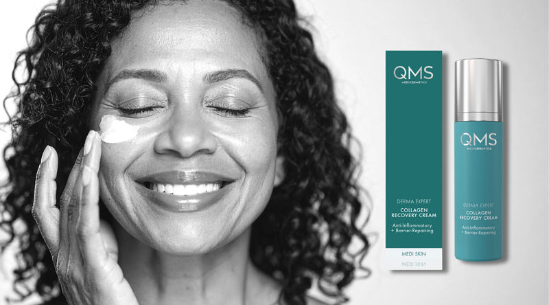 Woman applying cream to her face with QMS skincare products displayed.
