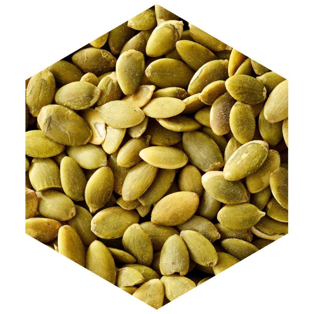 Hexagonal arrangement of green pumpkin seeds on a white background